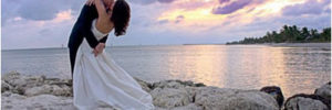 recently married couple kissing on a Key West beach at sunset