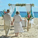 Beautiful happy elderly couple renewing their vows on the beach